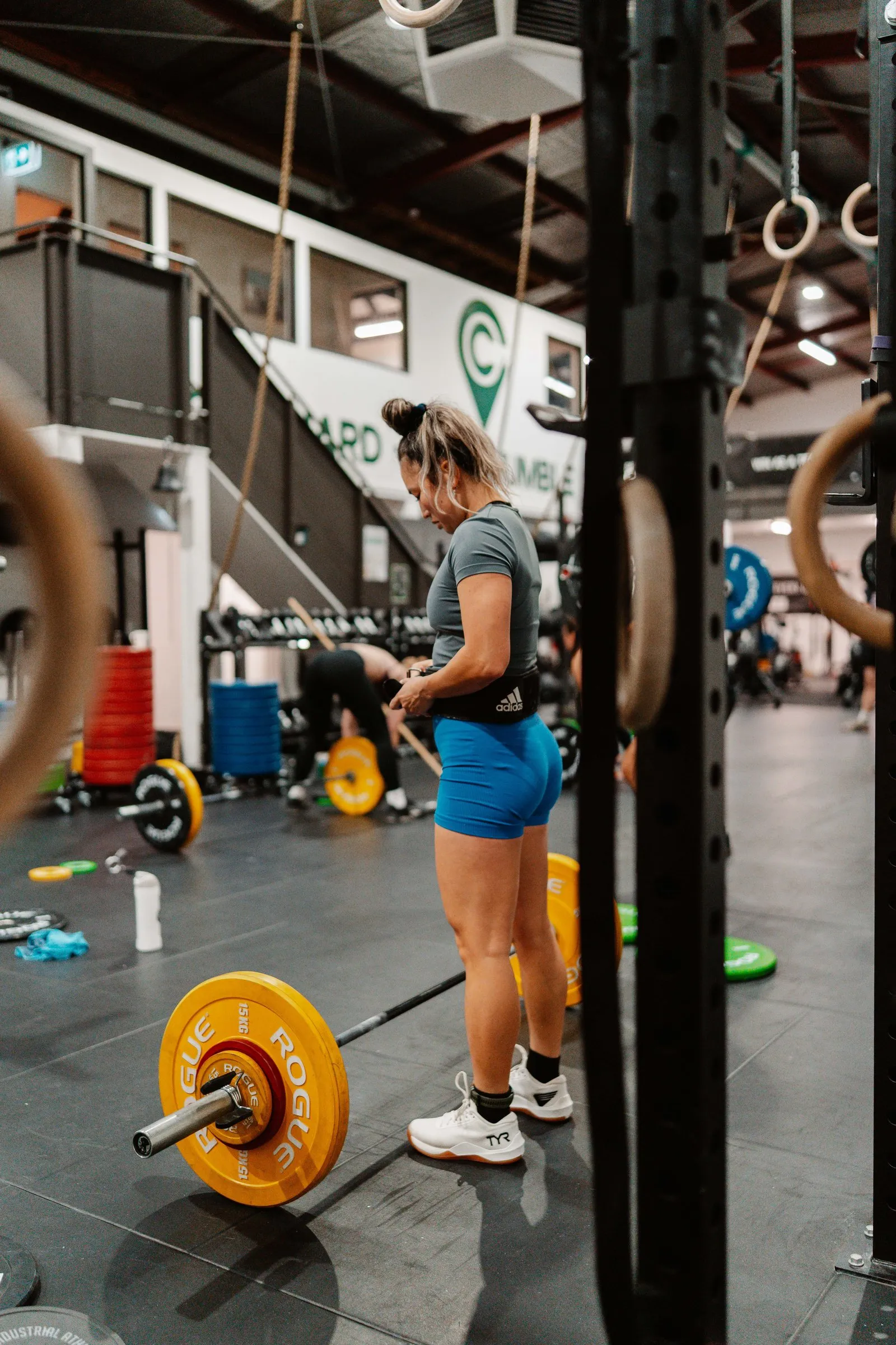 A lifter setting up over a loaded barbell at Lifting Club.